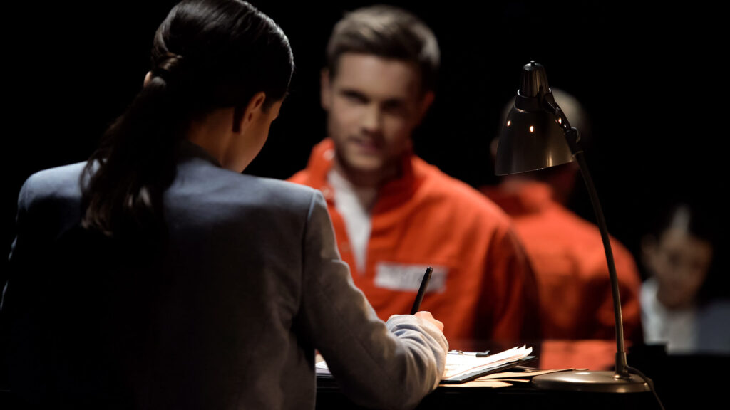 a man is arrested and setting in front of a lawyer